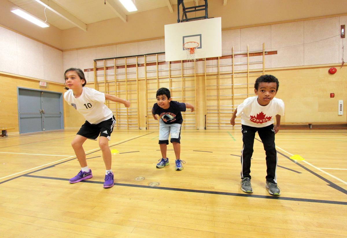 Three young children preparing to jump